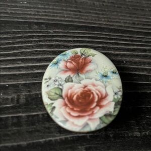 Vintage oval brooch with hand painted rose bouquet on a glass cameo on copper.